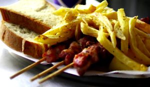 Souvlaki skewers with fries and grilled pita bread